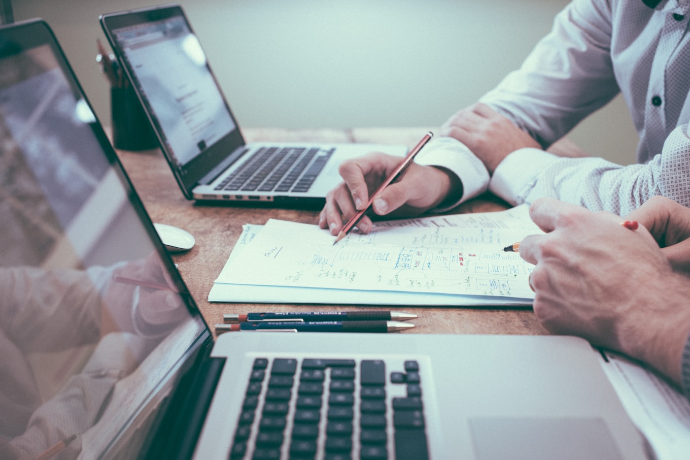 Finance professional reviewing plans and spreadsheets at a desk