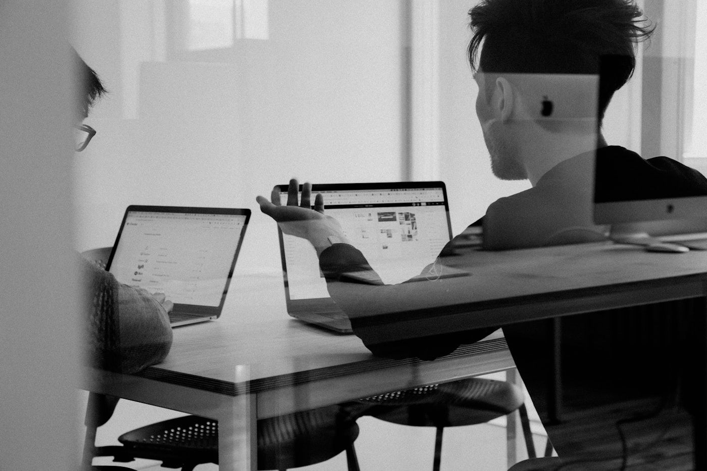 Colleagues reviewing data on a laptop